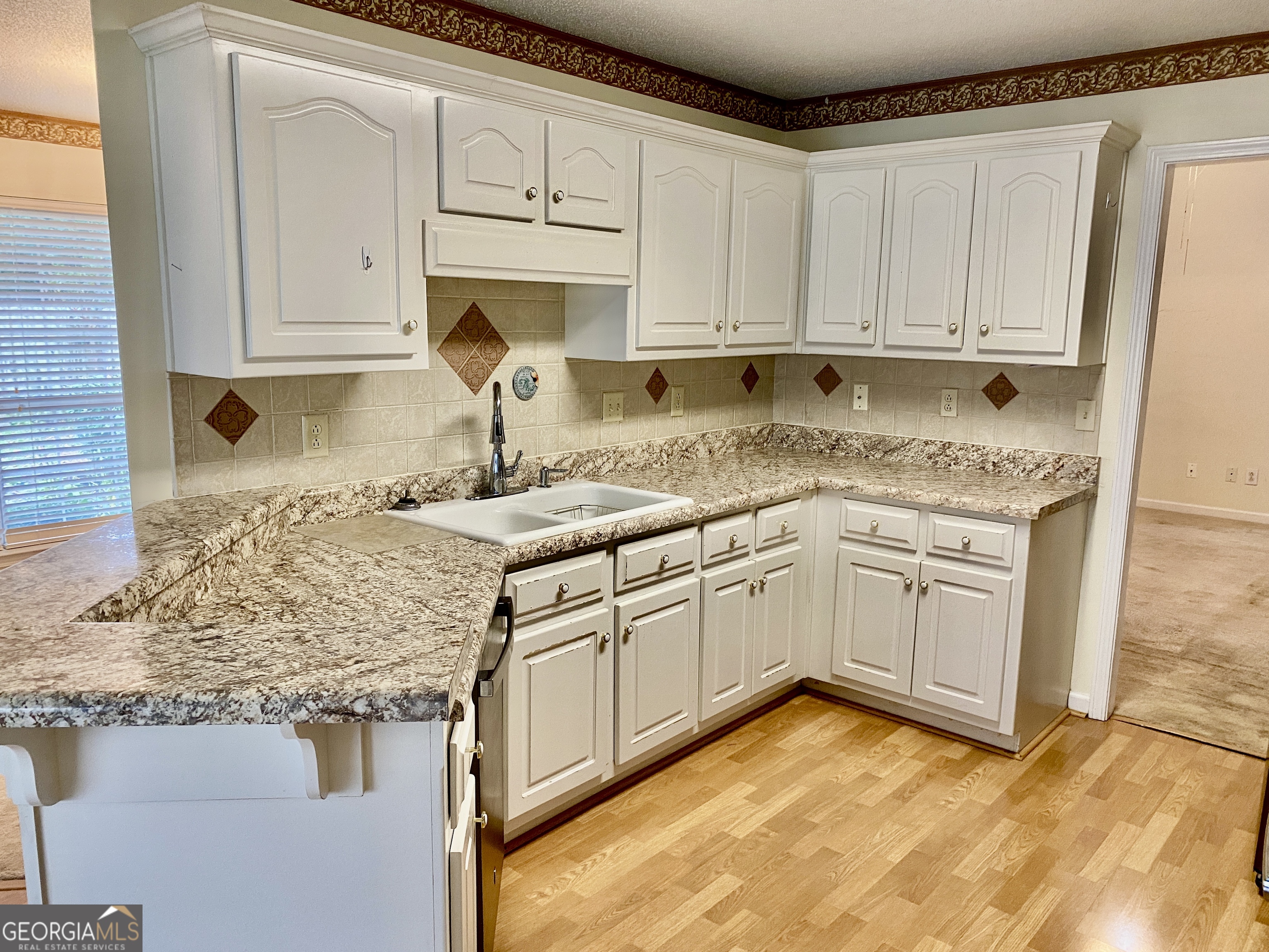 38 Boulder Drive Northwest Rome, GA 30165 - Photo 7 of 21 a kitchen with granite countertop white cabinets and white appliances