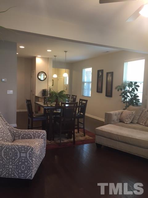 738 Wickham Ridge Road Apex, NC 27539 - Photo 11 of 23 a living room with furniture and a chandelier
