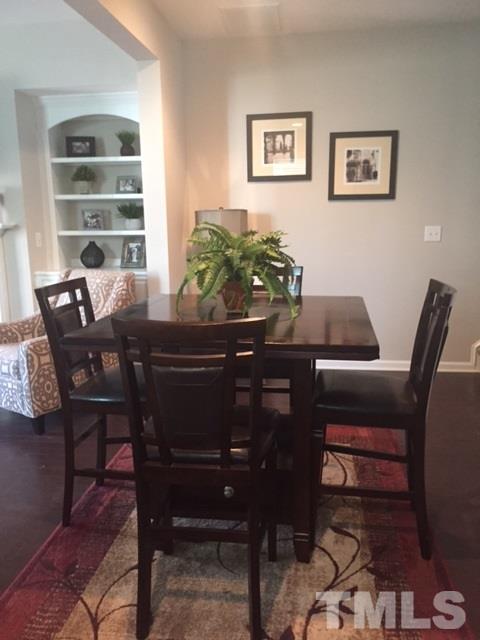 738 Wickham Ridge Road Apex, NC 27539 - Photo 14 of 23 a view of a dining room with furniture and a window