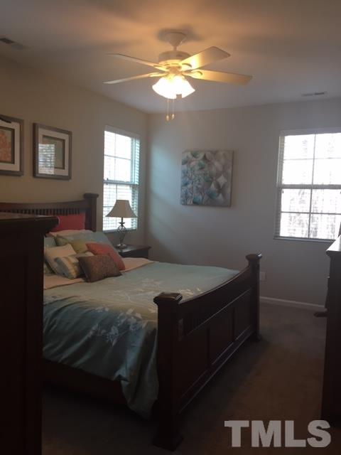 738 Wickham Ridge Road Apex, NC 27539 - Photo 15 of 23 a bed sitting in a bedroom next to a window
