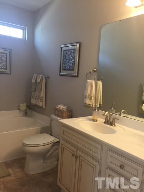 738 Wickham Ridge Road Apex, NC 27539 - Photo 17 of 23 a bathroom with a sink toilet and shower