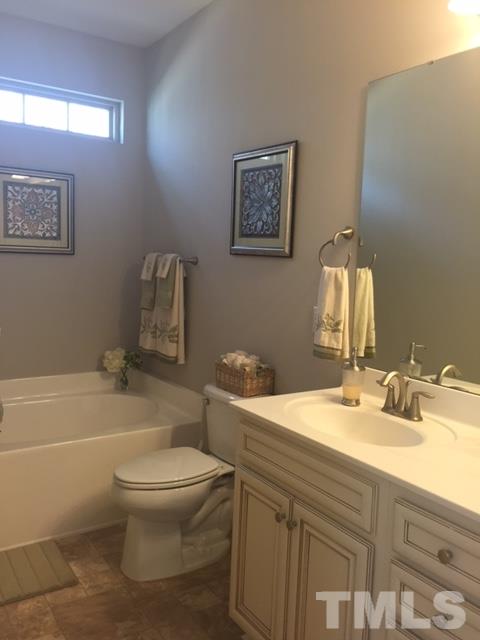 738 Wickham Ridge Road Apex, NC 27539 - Photo 18 of 23 a bathroom with a sink toilet and shower