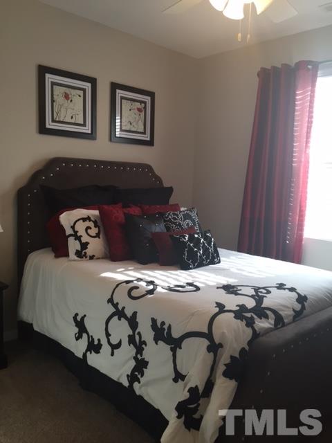 738 Wickham Ridge Road Apex, NC 27539 - Photo 7 of 23 a bedroom with a bed and a window