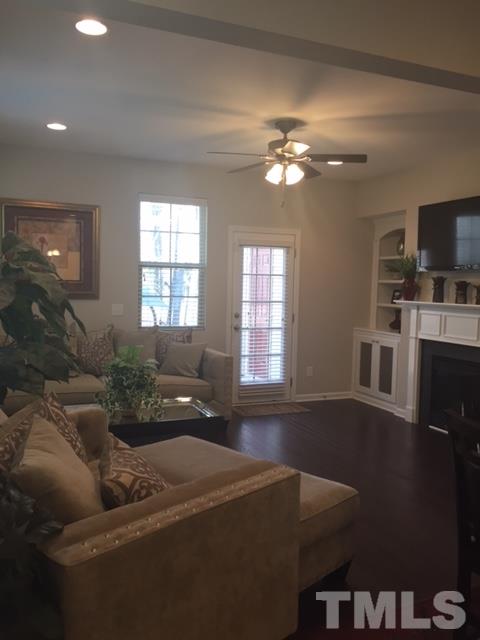 738 Wickham Ridge Road Apex, NC 27539 - Photo 9 of 23 a living room with furniture and a chandelier