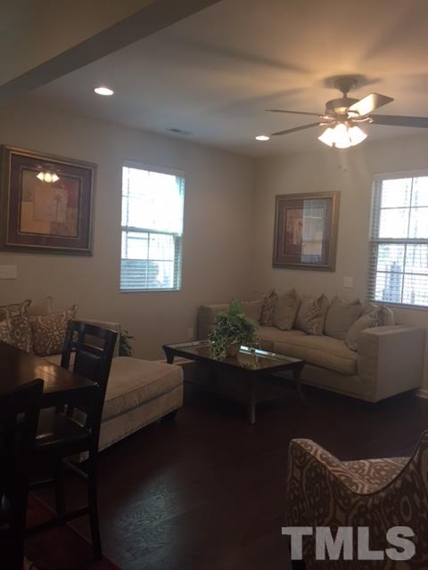 738 Wickham Ridge Road Apex, NC 27539 - Photo 10 of 23 a living room with furniture and a chandelier