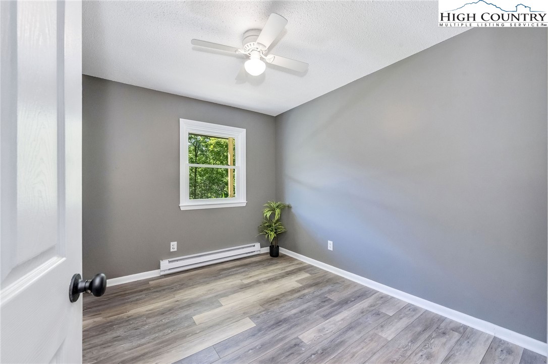 393 Carter Miller Road Todd, NC 28684 - Photo 18 of 48 an empty room with windows and fan