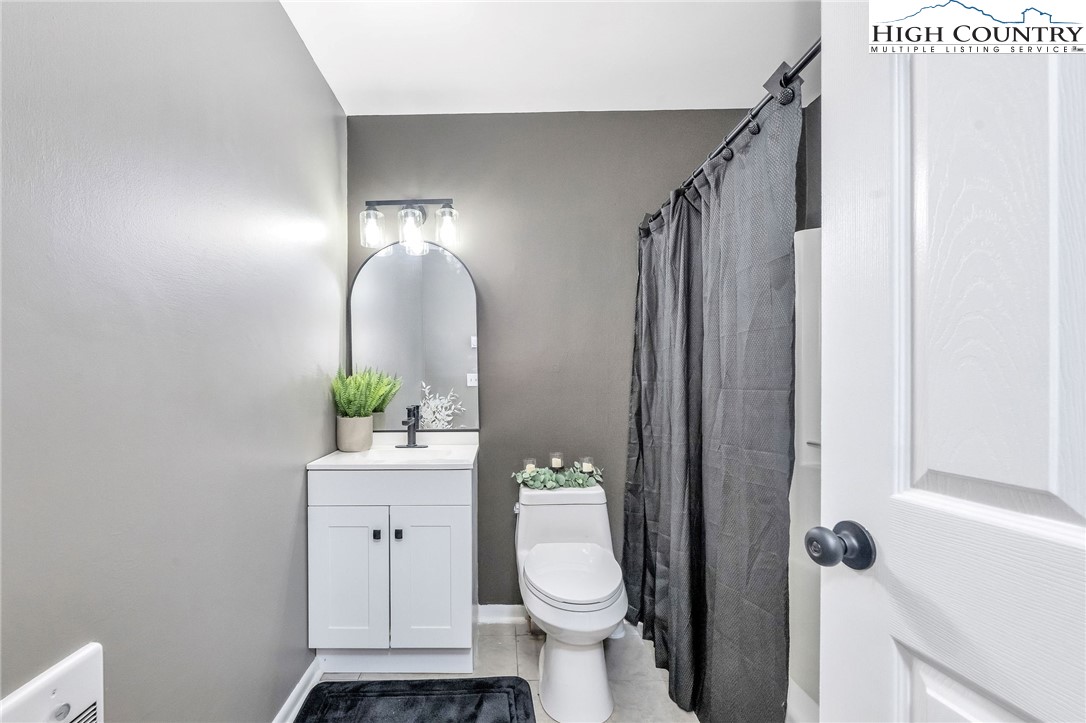 393 Carter Miller Road Todd, NC 28684 - Photo 20 of 48 a bathroom with a toilet and a mirror