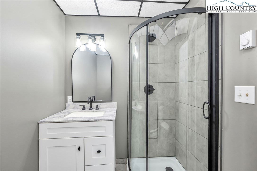 393 Carter Miller Road Todd, NC 28684 - Photo 43 of 48 a bathroom with a sink shower and a mirror