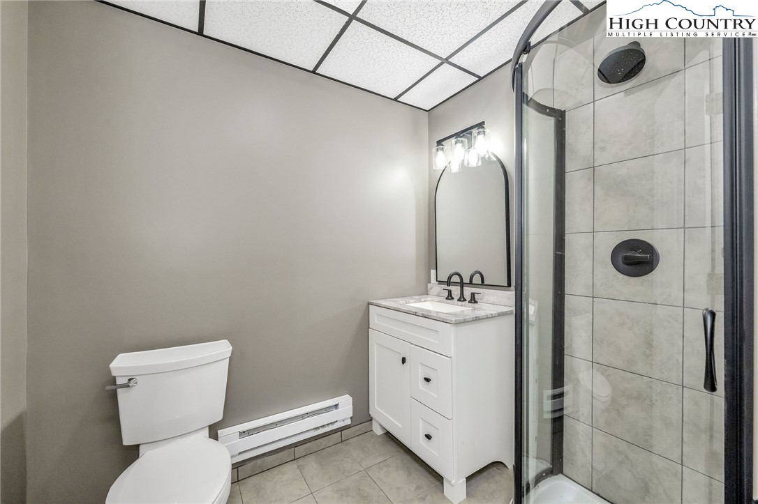 393 Carter Miller Road Todd, NC 28684 - Photo 44 of 48 a bathroom with a toilet sink and shower