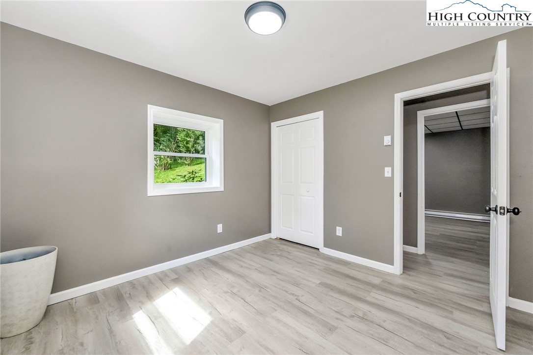 393 Carter Miller Road Todd, NC 28684 - Photo 46 of 48 a view of empty room with wooden floor and fan