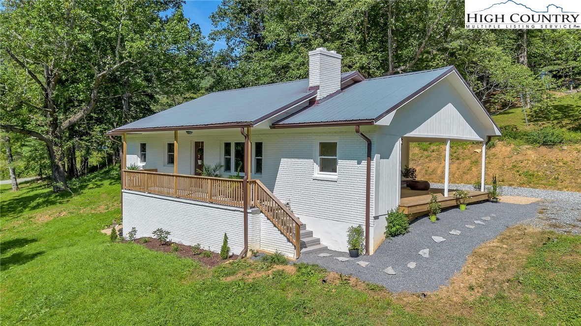 393 Carter Miller Road Todd, NC 28684 - Photo 5 of 48 a front view of a house with garden
