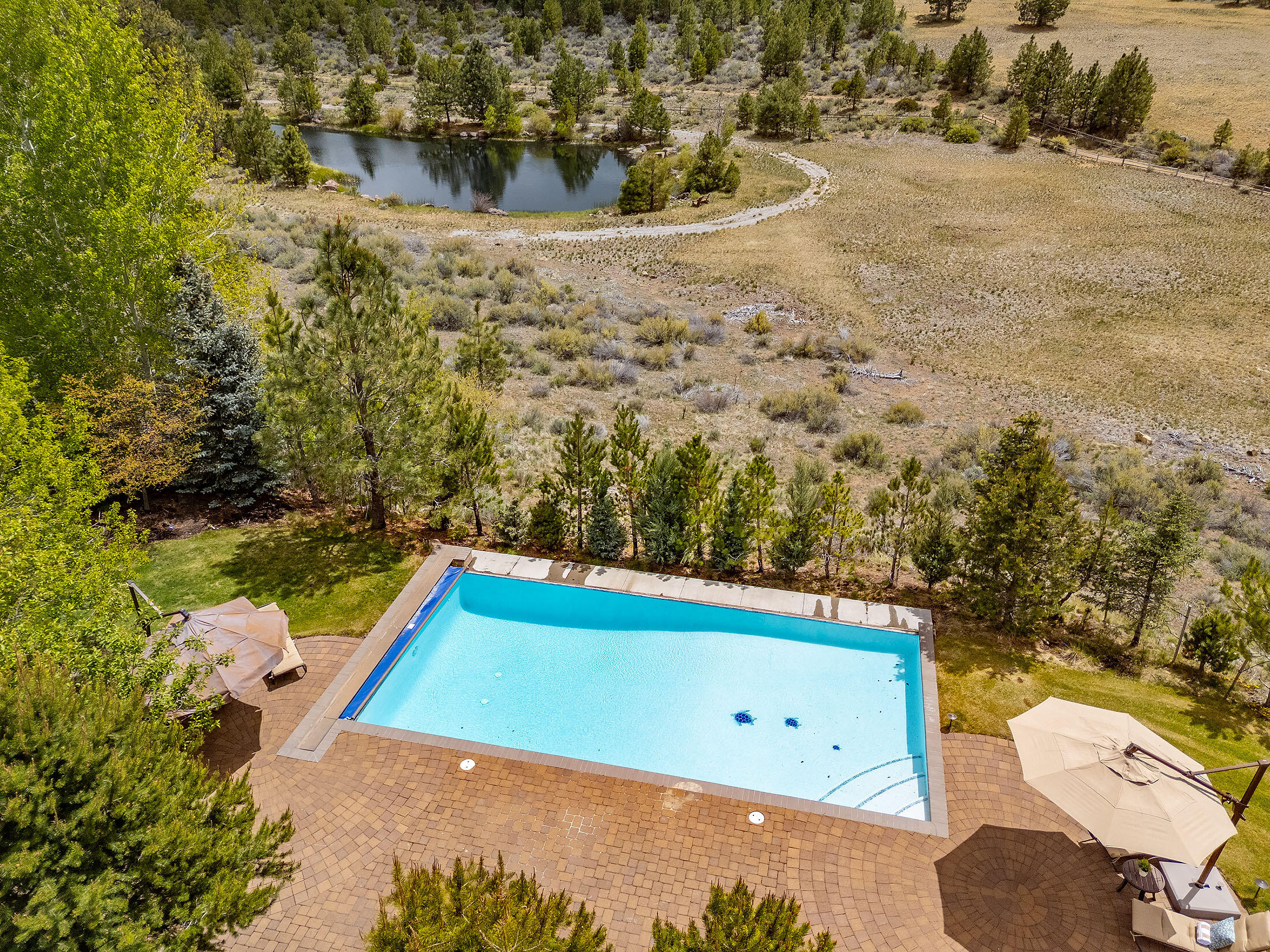 18883 Sutherland Court Bend, OR 97702 - Photo 62 of 70 A rare combination of water features?sparkling pool alongside a tranquil pond.