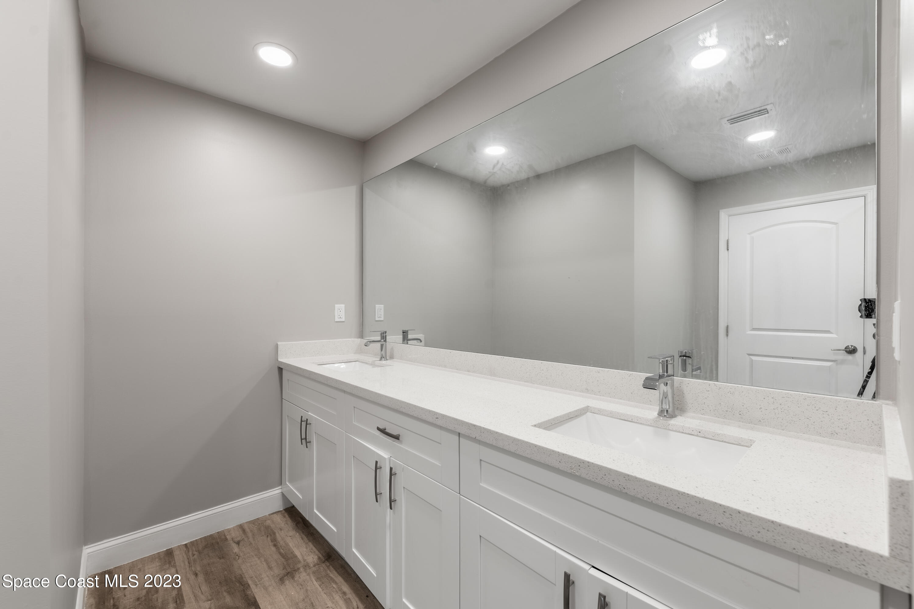 6641 Cecil Road Cocoa, FL 32927 - Photo 11 of 28 a bathroom with a double vanity sink and a mirror
