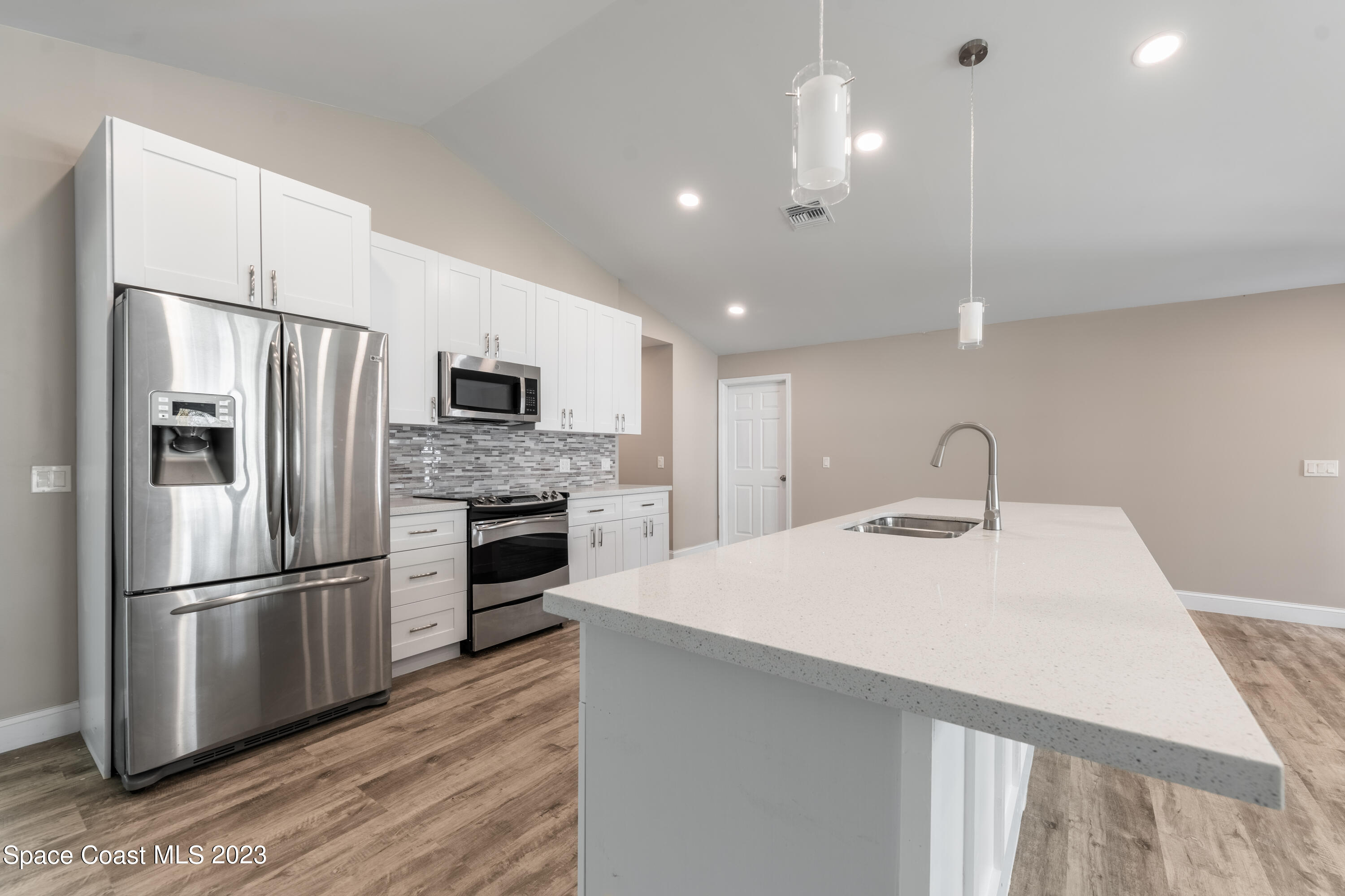 6641 Cecil Road Cocoa, FL 32927 - Photo 3 of 28 a kitchen with a refrigerator sink and microwave
