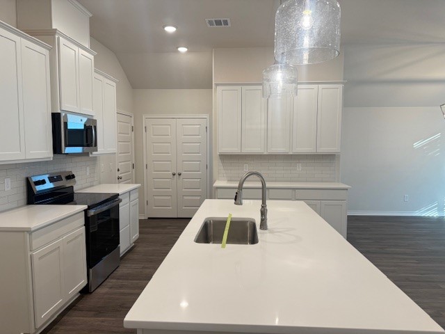 7809 Redbud Road Navasota, TX 77868 - Photo 16 of 18 a kitchen with a sink a stove and cabinets