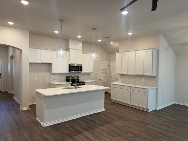 7809 Redbud Road Navasota, TX 77868 - Photo 4 of 18 a kitchen with white cabinets and stainless steel appliances