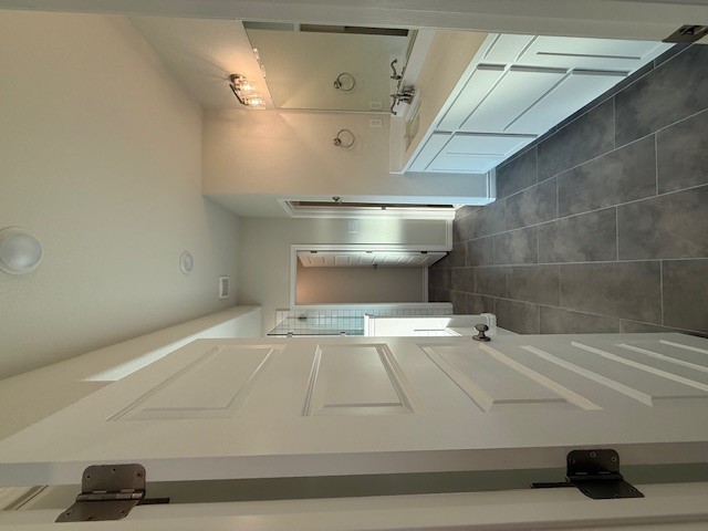 7809 Redbud Road Navasota, TX 77868 - Photo 8 of 18 a large bathroom with a glass shower door a sink and a mirror