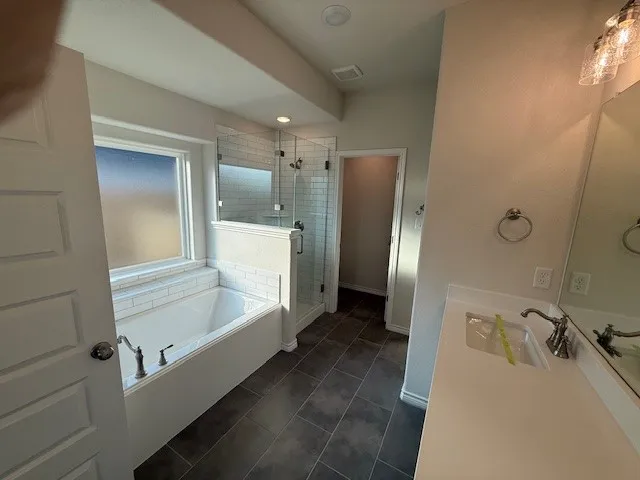 a bathroom with a bathtub and a shower