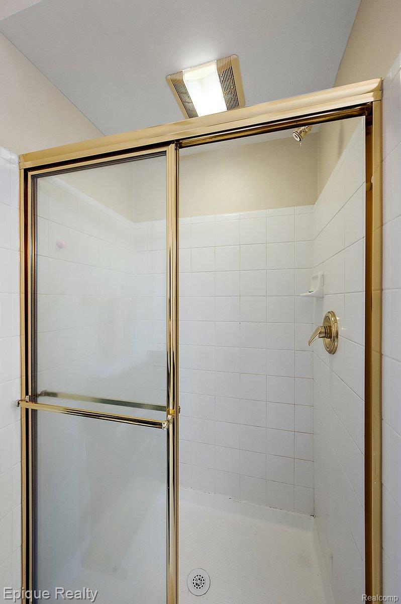 1909 Catlin Drive Rochester, MI 48306 - Photo 31 of 76 Shower enclosure featuring gold-tone framing and clear glass panels
