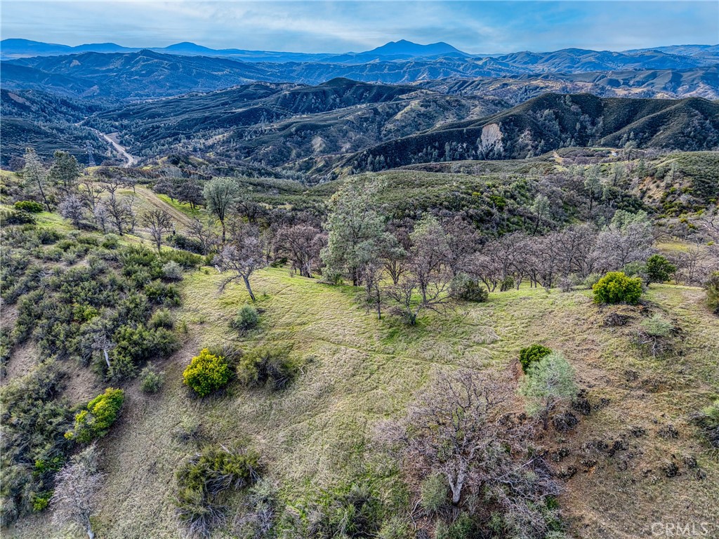 162 Mule Skinner Road Clearlake Oaks, CA 95423 - Photo 18 of 25 a view of a lush green hillside and a houses