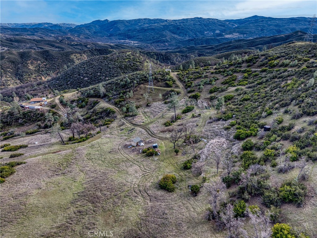 162 Mule Skinner Road Clearlake Oaks, CA 95423 - Photo 20 of 25 a view of a dry field with trees in the background