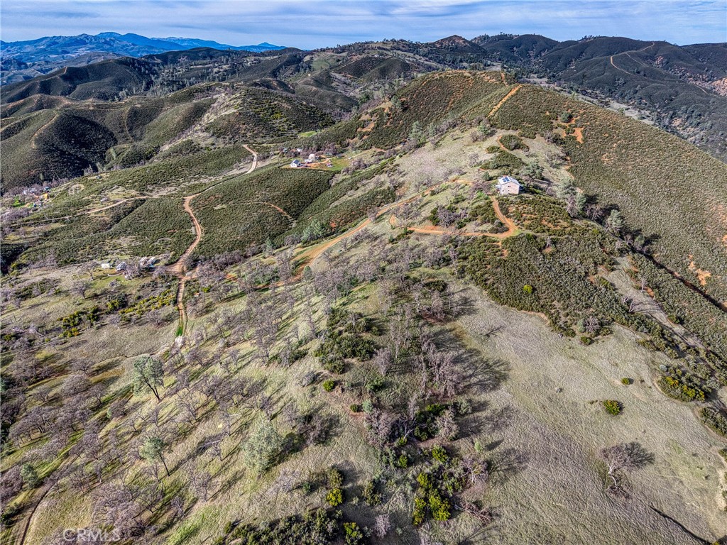 162 Mule Skinner Road Clearlake Oaks, CA 95423 - Photo 3 of 25 a view of a forest with mountains in the background