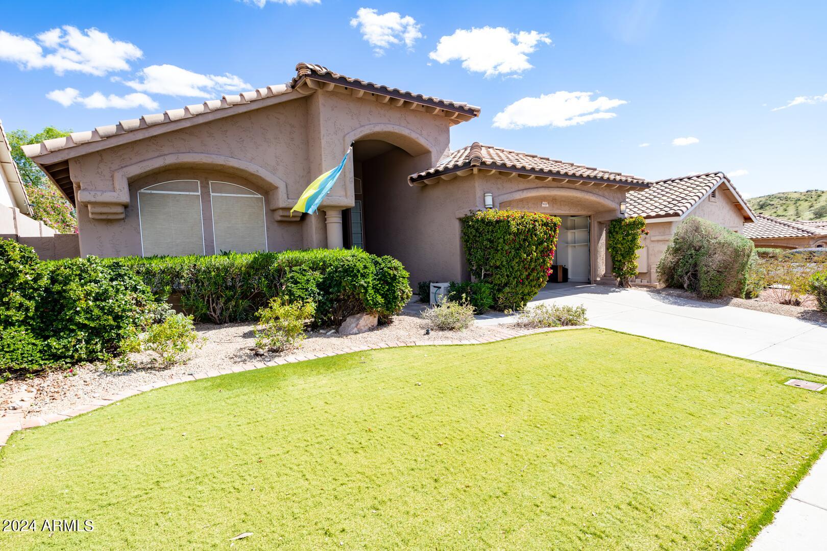 16051 South 24th Place Phoenix, AZ 85048 - Photo 1 of 42 a front view of a house with a yard
