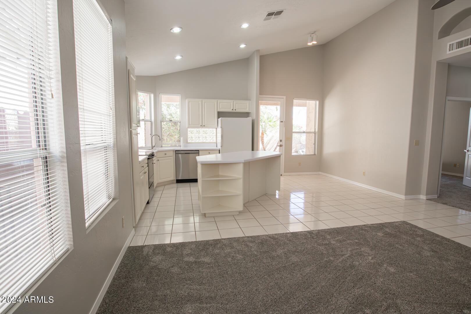 16051 South 24th Place Phoenix, AZ 85048 - Photo 17 of 42 a view of a kitchen with kitchen island wooden floor and outdoor living room
