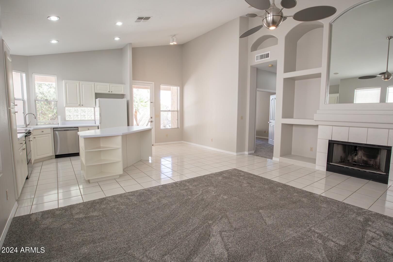 16051 South 24th Place Phoenix, AZ 85048 - Photo 18 of 42 a view of a kitchen with furniture and a fireplace