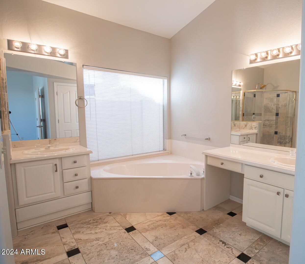 16051 South 24th Place Phoenix, AZ 85048 - Photo 24 of 42 a bathroom with a tub sink and mirror