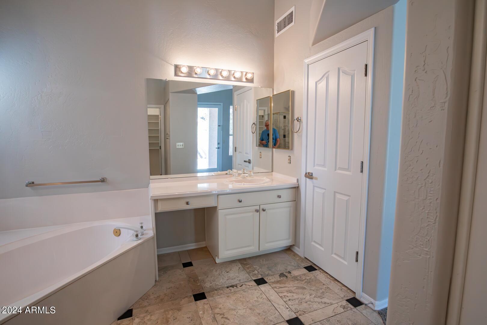 16051 South 24th Place Phoenix, AZ 85048 - Photo 25 of 42 a spacious bathroom with a bathtub sink and mirror