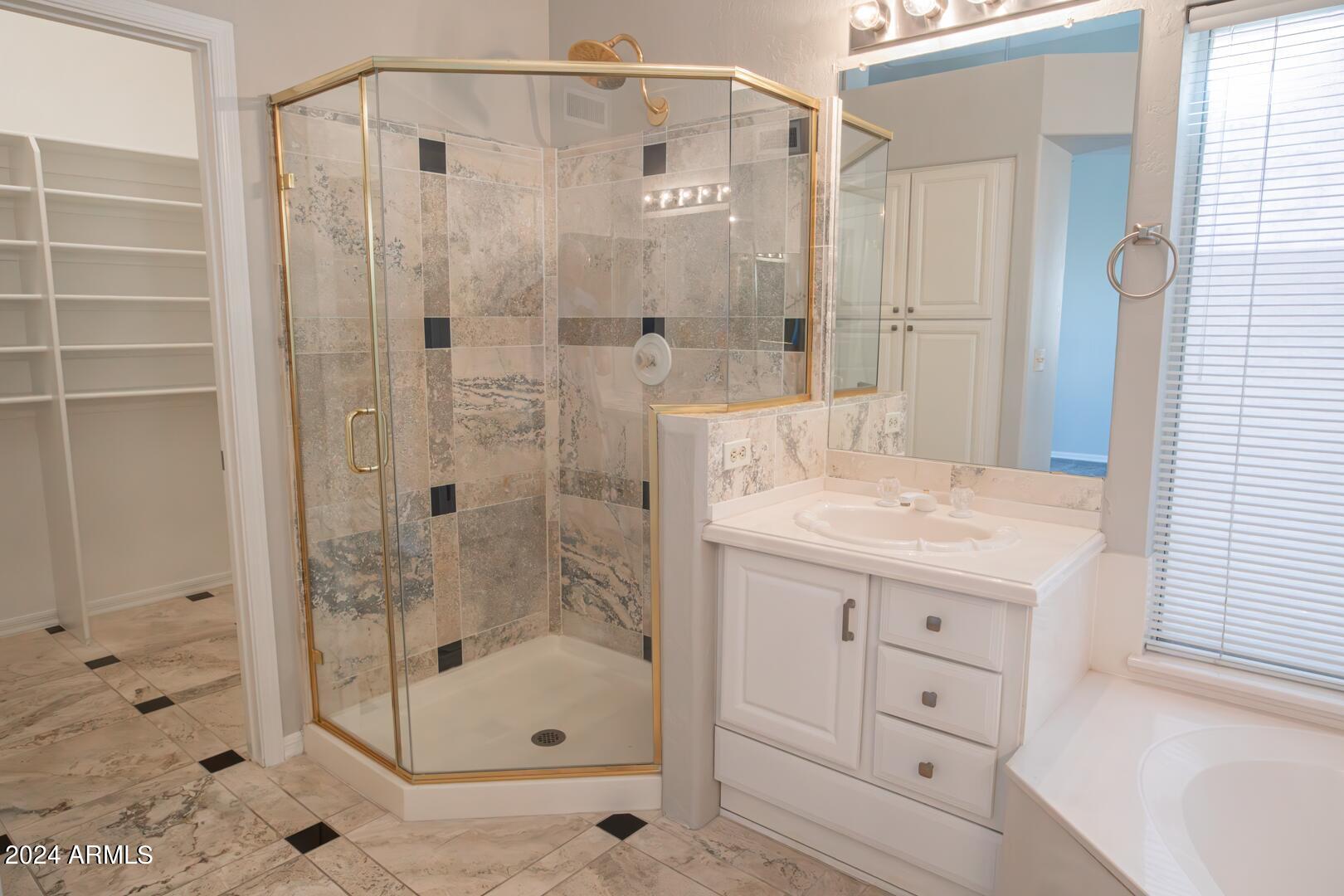 16051 South 24th Place Phoenix, AZ 85048 - Photo 27 of 42 a bathroom with a shower sink and mirror