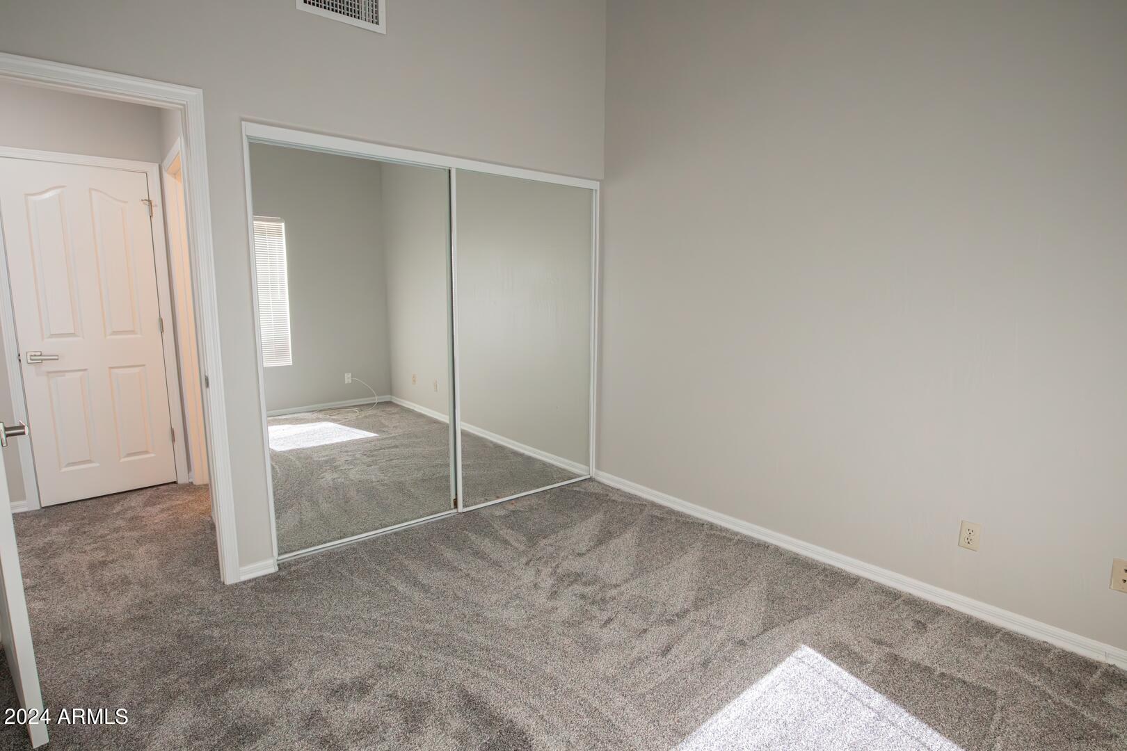 16051 South 24th Place Phoenix, AZ 85048 - Photo 32 of 42 an empty room with sliding door