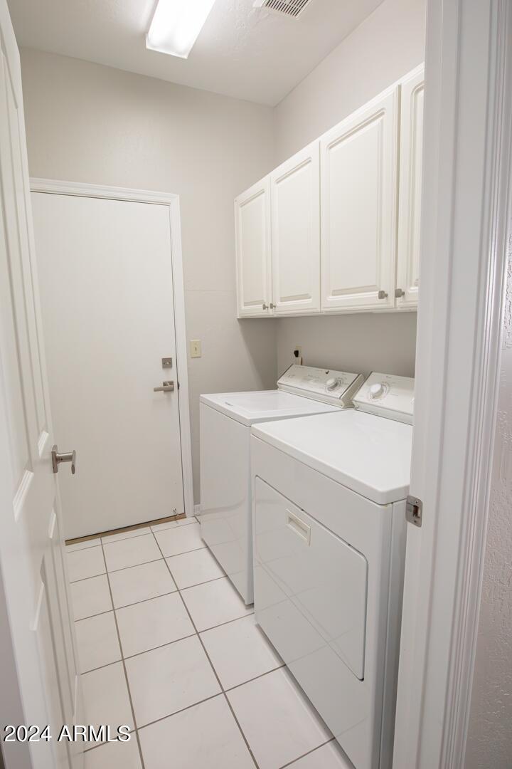 16051 South 24th Place Phoenix, AZ 85048 - Photo 35 of 42 a utility room with cabinets washer and dryer