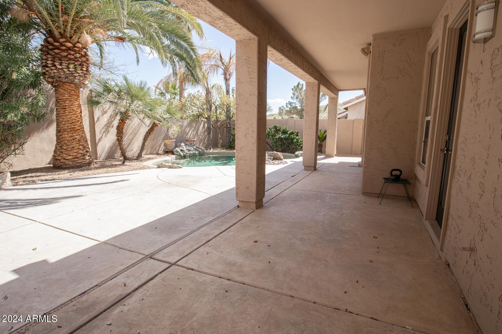 16051 South 24th Place Phoenix, AZ 85048 - Photo 36 of 42 a view of a porch with a floor to ceiling window and outside view