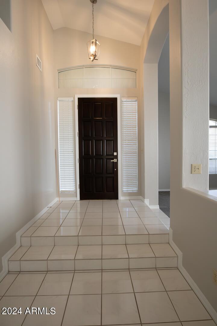 16051 South 24th Place Phoenix, AZ 85048 - Photo 7 of 42 a view of an empty room with window and chandelier