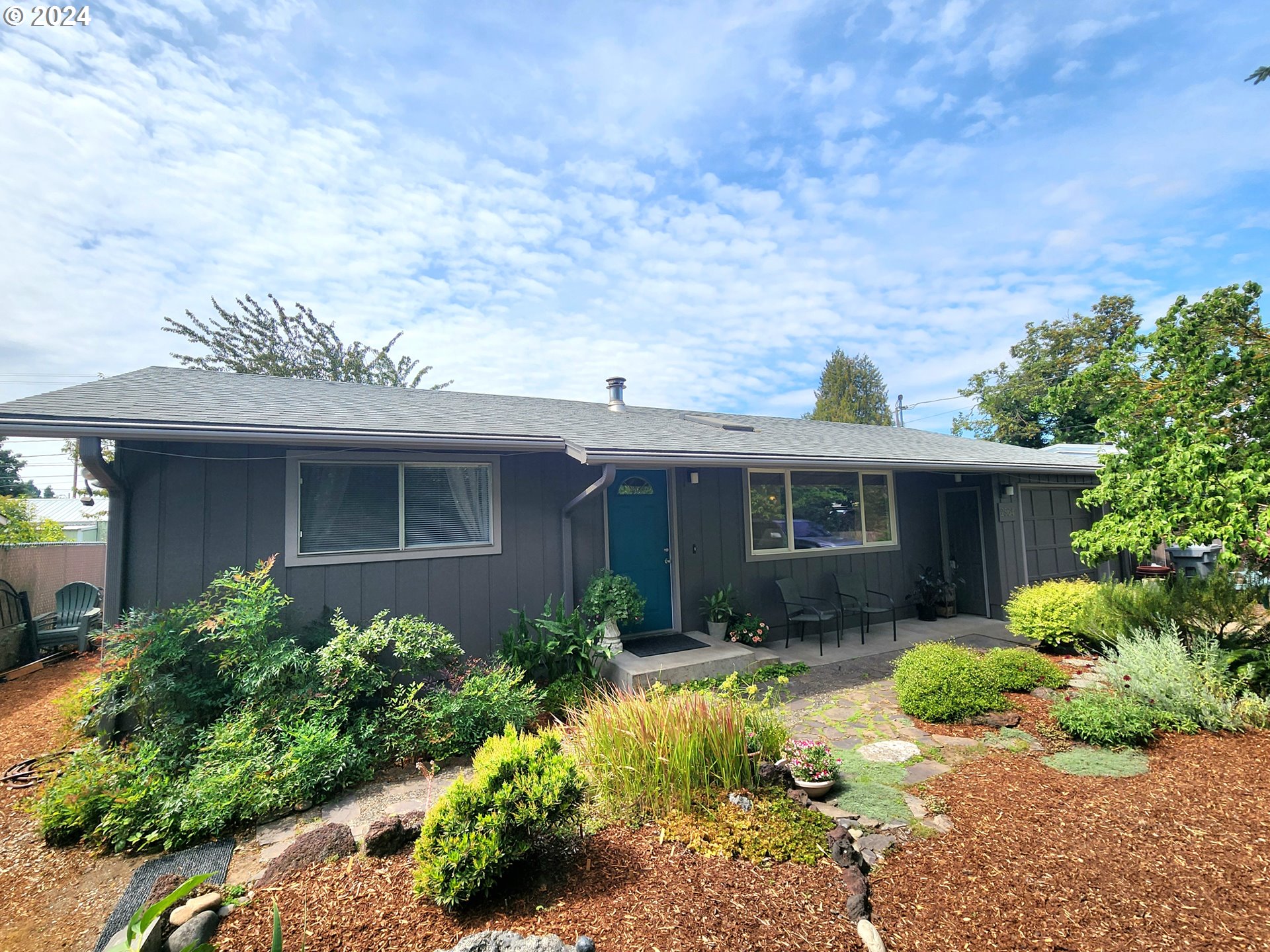 2564 Nova Street Springfield, OR 97477 - Photo 1 of 29 a view of a house with potted plants and a table and chairs