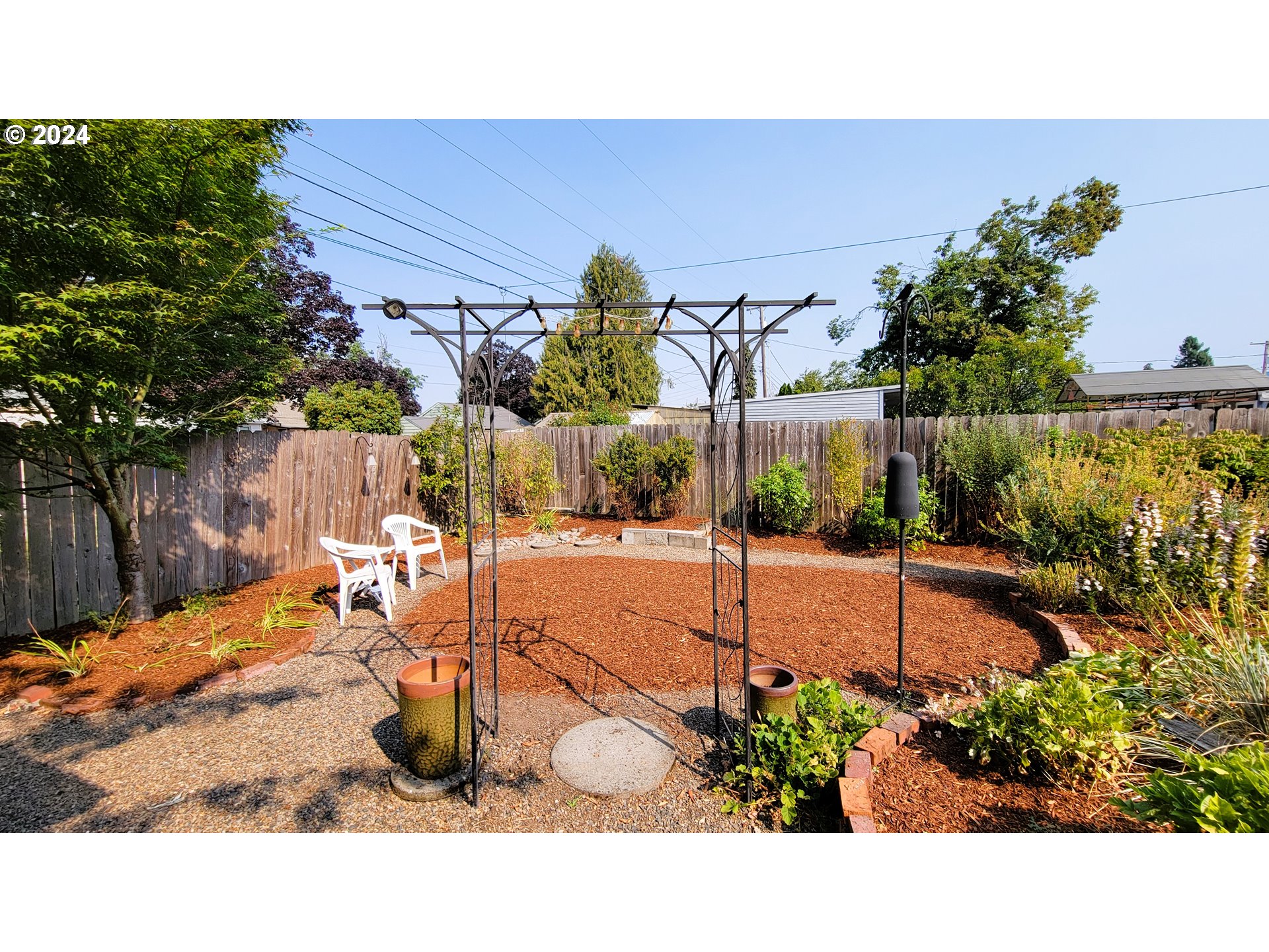 2564 Nova Street Springfield, OR 97477 - Photo 27 of 29 a balcony with table and chairs and potted plants