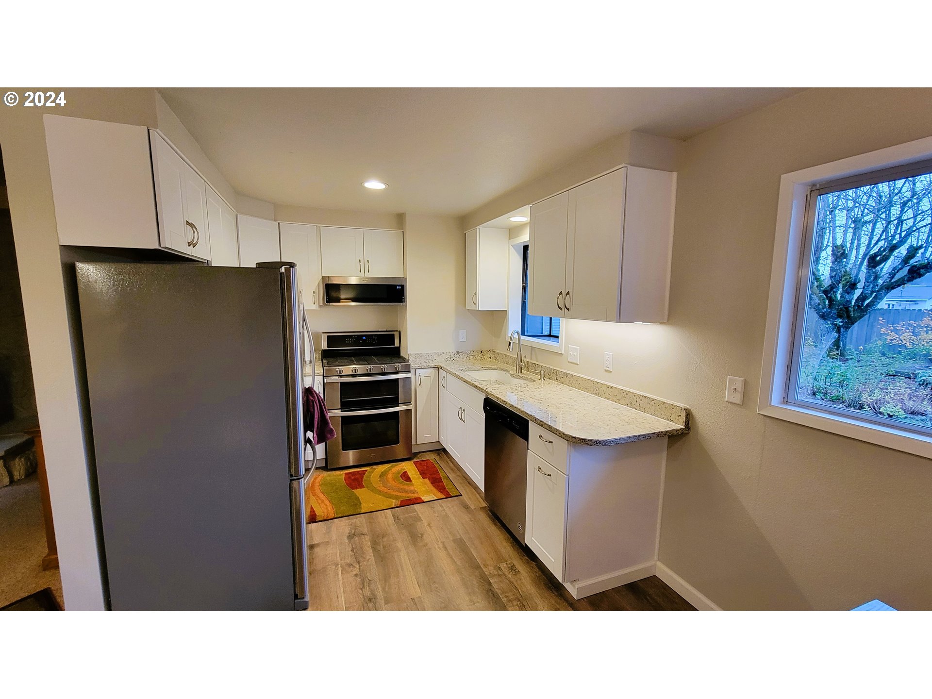 2564 Nova Street Springfield, OR 97477 - Photo 7 of 29 a kitchen with stainless steel appliances kitchen island sink refrigerator and stove