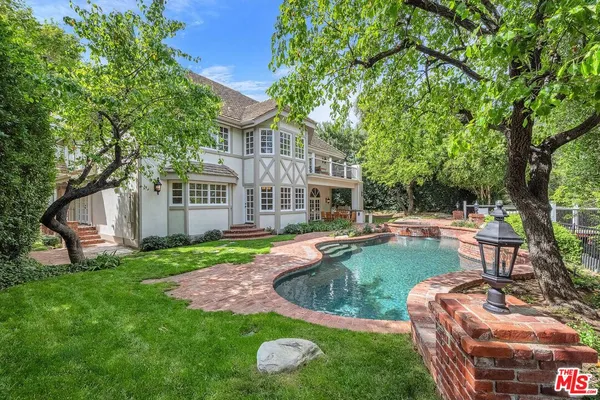 a view of a house with backyard porch and sitting area