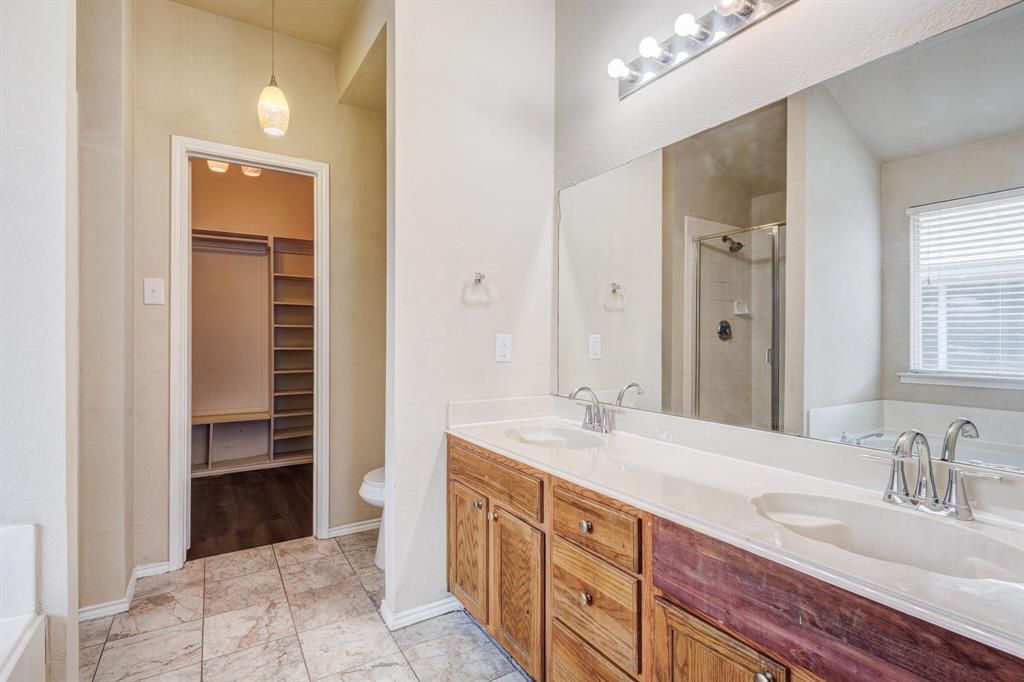 7310 Northpoint Drive Rowlett, TX 75089 - Photo 13 of 32 a spacious bathroom with a sink a vanity and a mirror