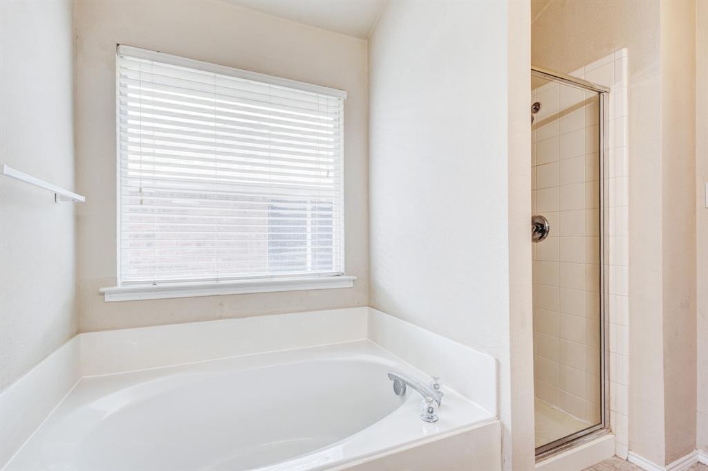 7310 Northpoint Drive Rowlett, TX 75089 - Photo 14 of 32 a white bath tub sitting next to a window