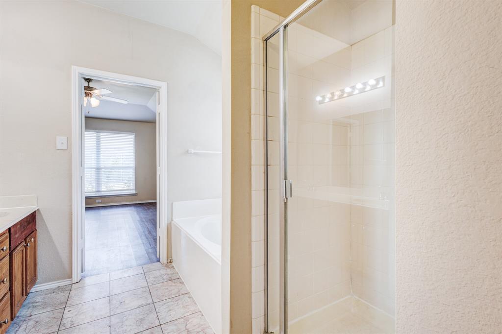 7310 Northpoint Drive Rowlett, TX 75089 - Photo 15 of 32 a bathroom with a bathtub and a shower