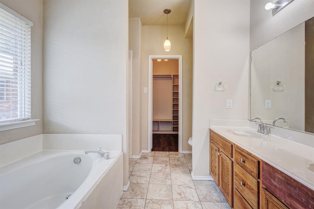 7310 Northpoint Drive Rowlett, TX 75089 - Photo 16 of 32 a spacious bathroom with a tub sink and mirror