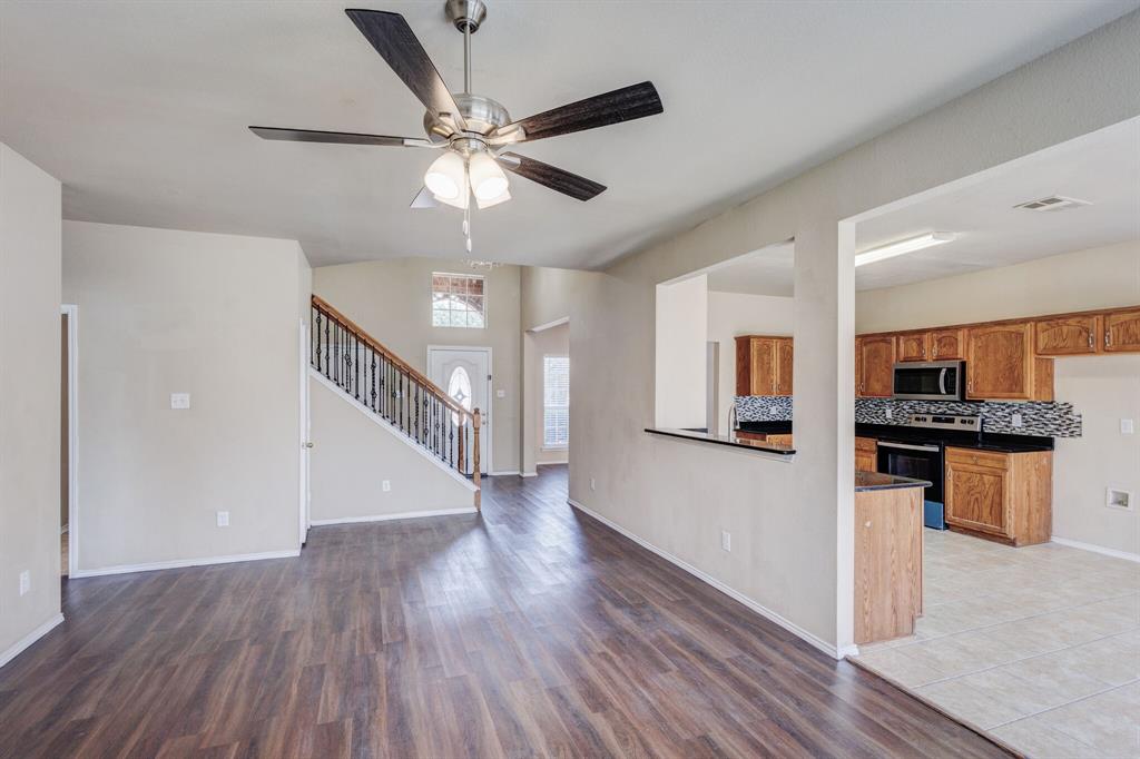 7310 Northpoint Drive Rowlett, TX 75089 - Photo 18 of 32 a view of a hallway with wooden floor and cabinet