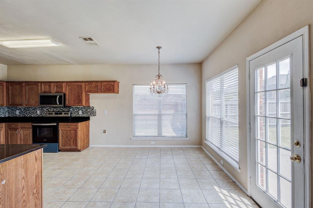 7310 Northpoint Drive Rowlett, TX 75089 - Photo 19 of 32 a view of a kitchen with a sink and windows