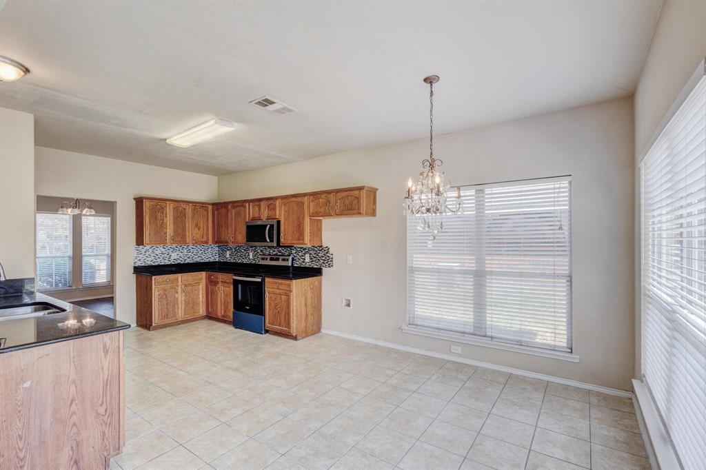 7310 Northpoint Drive Rowlett, TX 75089 - Photo 20 of 32 a kitchen that has a lot of windows in it