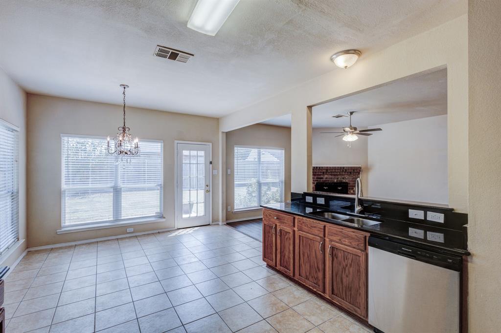 7310 Northpoint Drive Rowlett, TX 75089 - Photo 23 of 32 a kitchen with stainless steel appliances a stove sink and cabinets