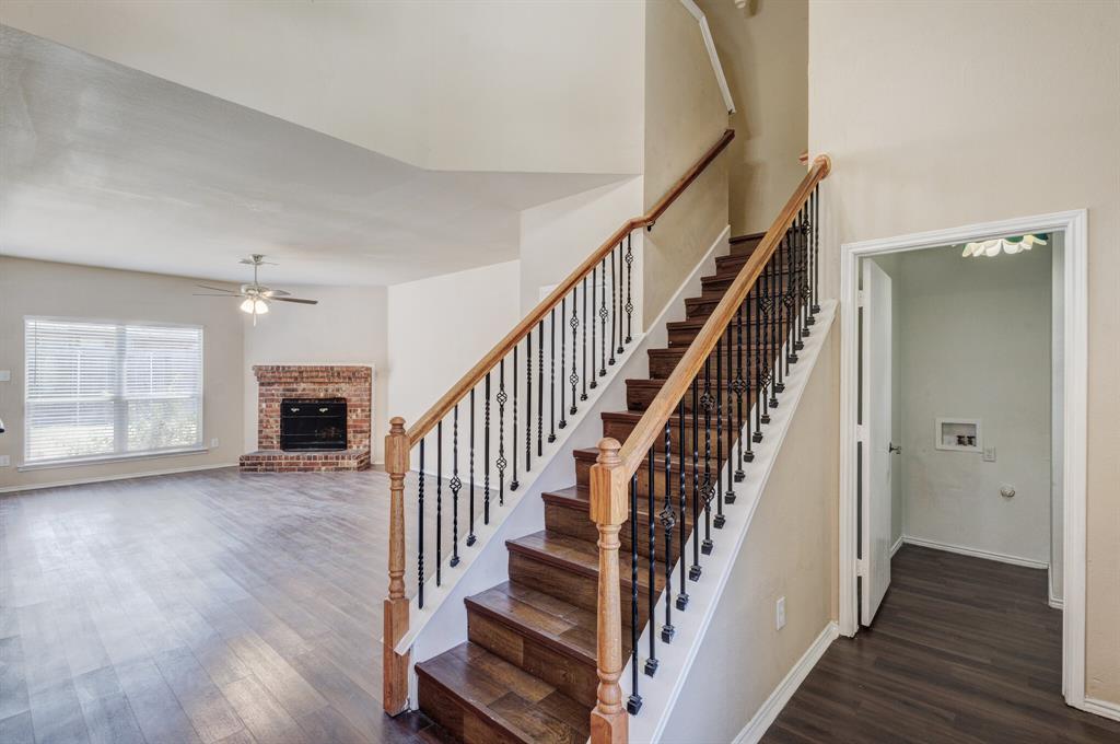 7310 Northpoint Drive Rowlett, TX 75089 - Photo 4 of 32 a view of a hallway with wooden floor and staircase