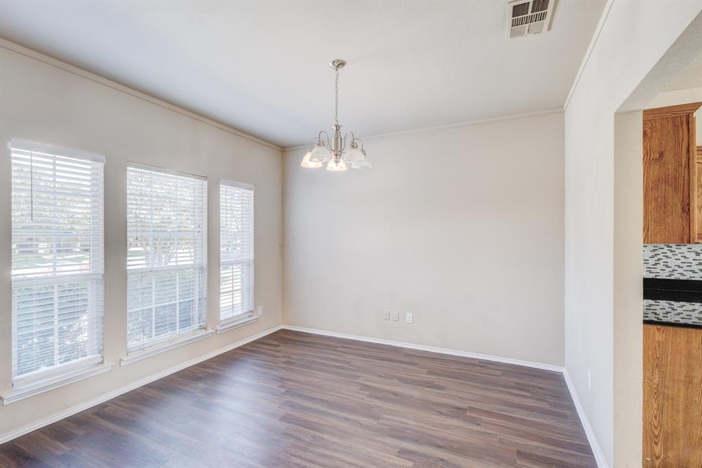 7310 Northpoint Drive Rowlett, TX 75089 - Photo 5 of 32 a view of a room with wooden floor fridge and a window